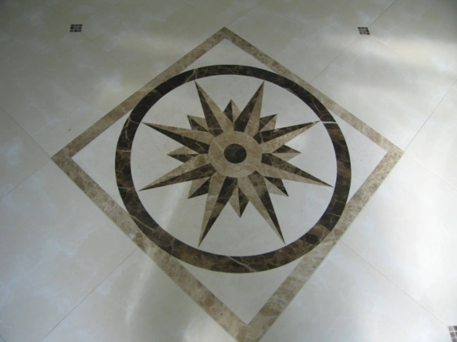 Inlay - Close-up view of main inlay in large foyer with tile inlays