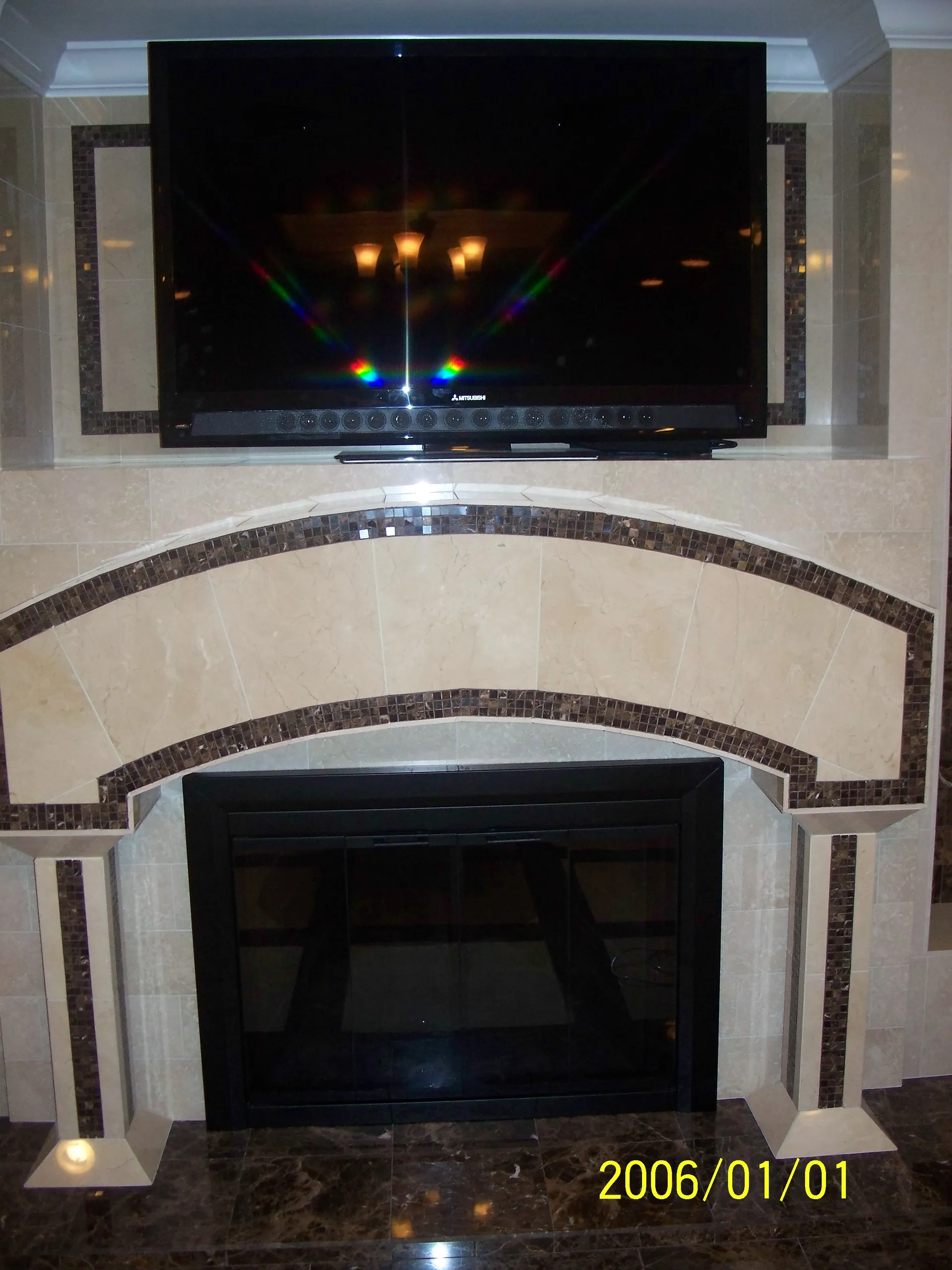 Custom Fireplace - Close-up view in living room showing custom built and tiled fireplace mantel