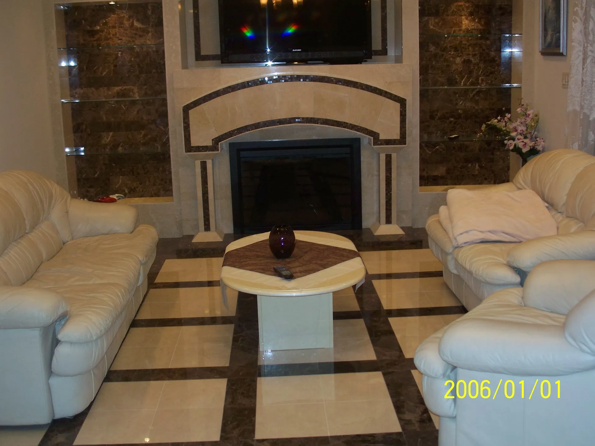 Living Room - Wide view of living room showing custom fireplace, custom shelving from tile, and custom patterned floor tile