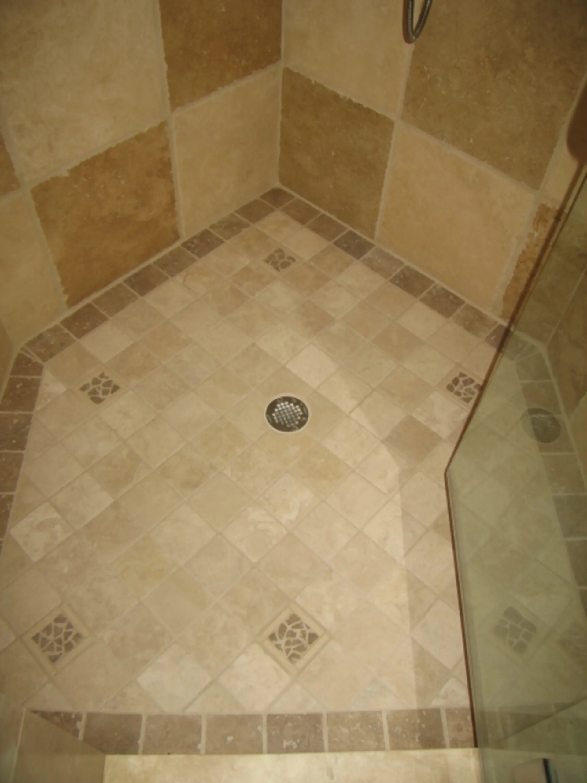 Master Bath - Shower pan view of custom bath with natural stone, shower pan with border and tile inlays