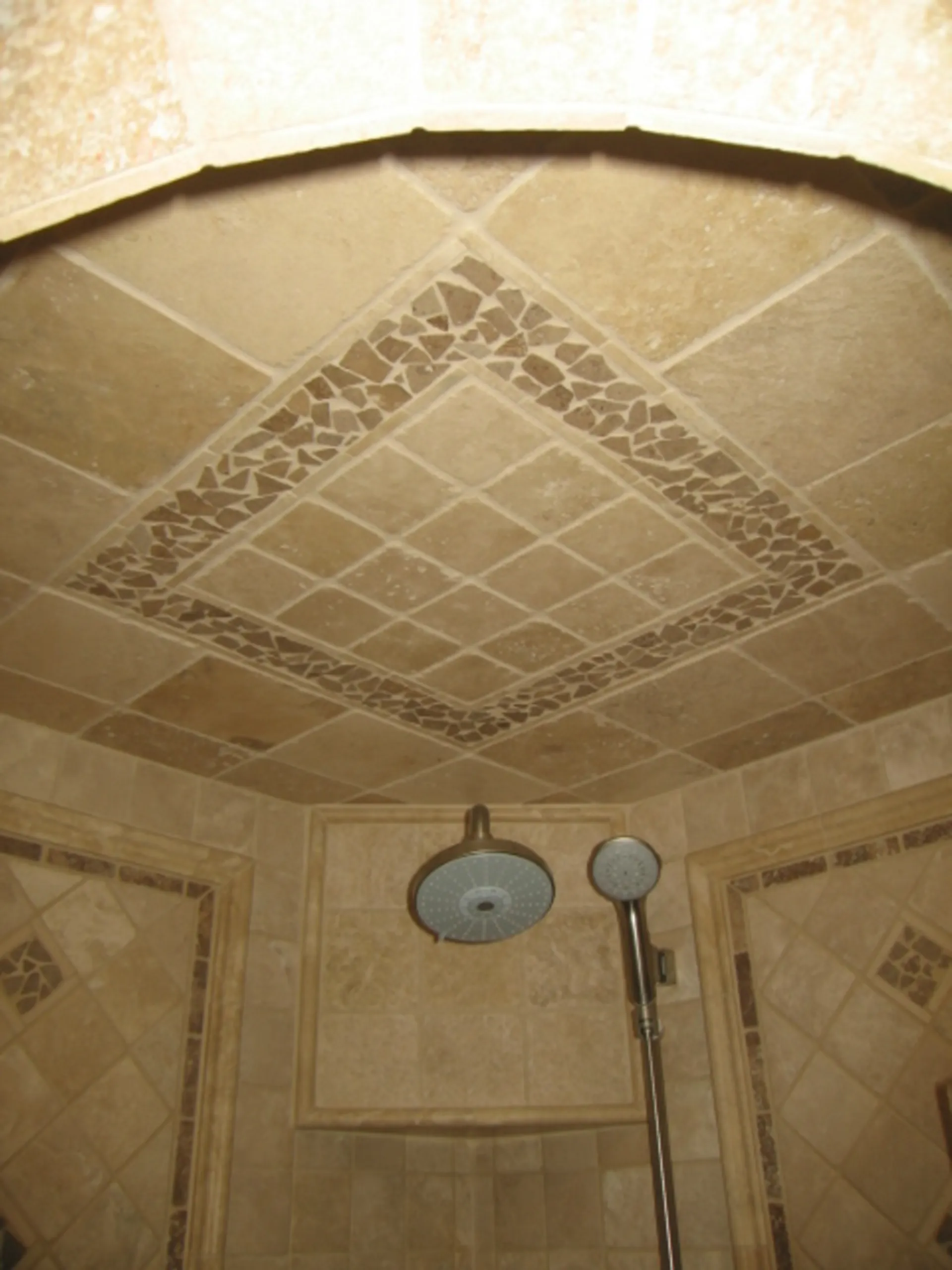 Master Bath - Ceiling view inside shower of custom bath with natural stone showing ceiling tile inlay