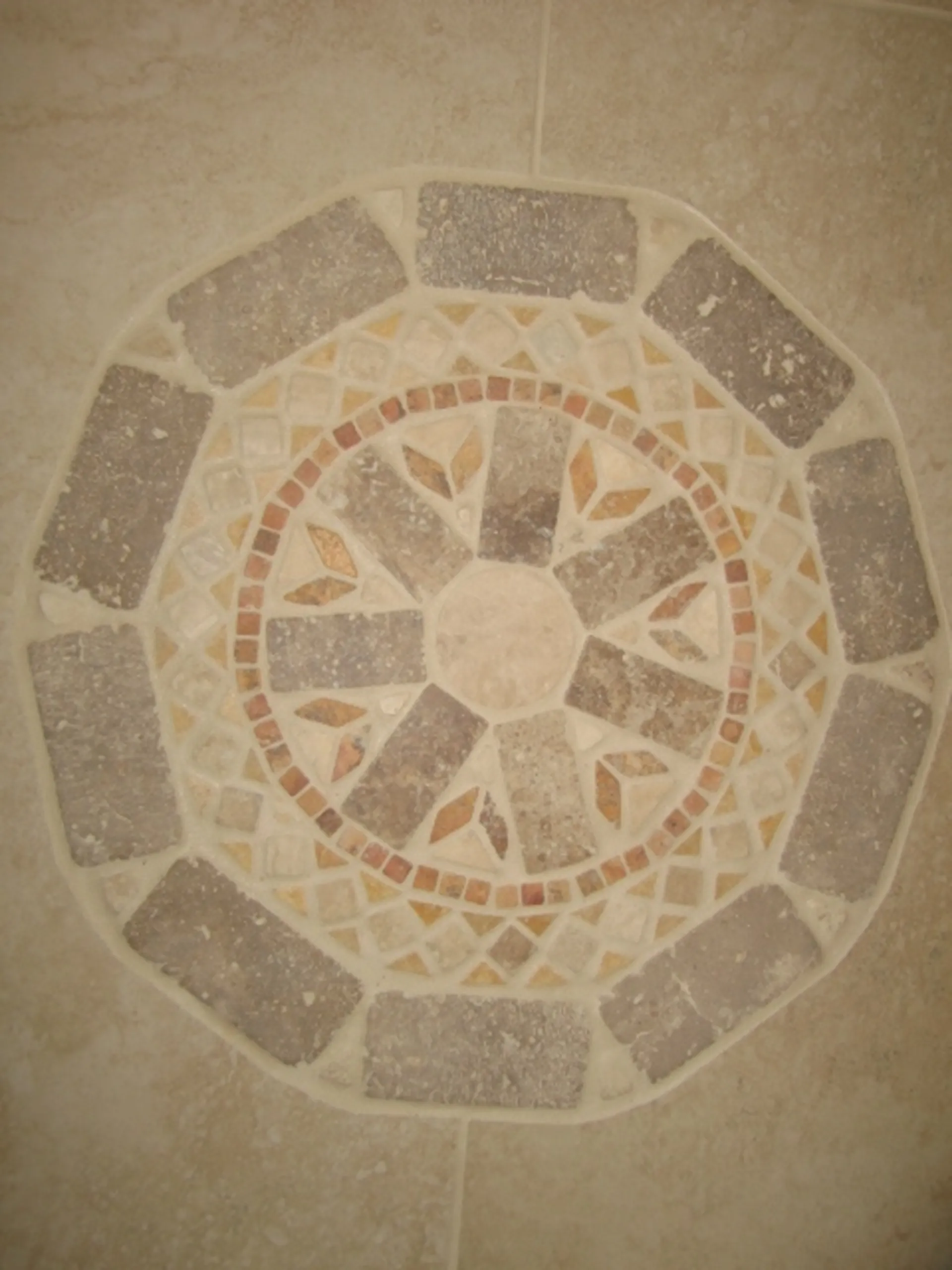 Foyer - Close-up view of handcrafted circular tile inlay inside foyer