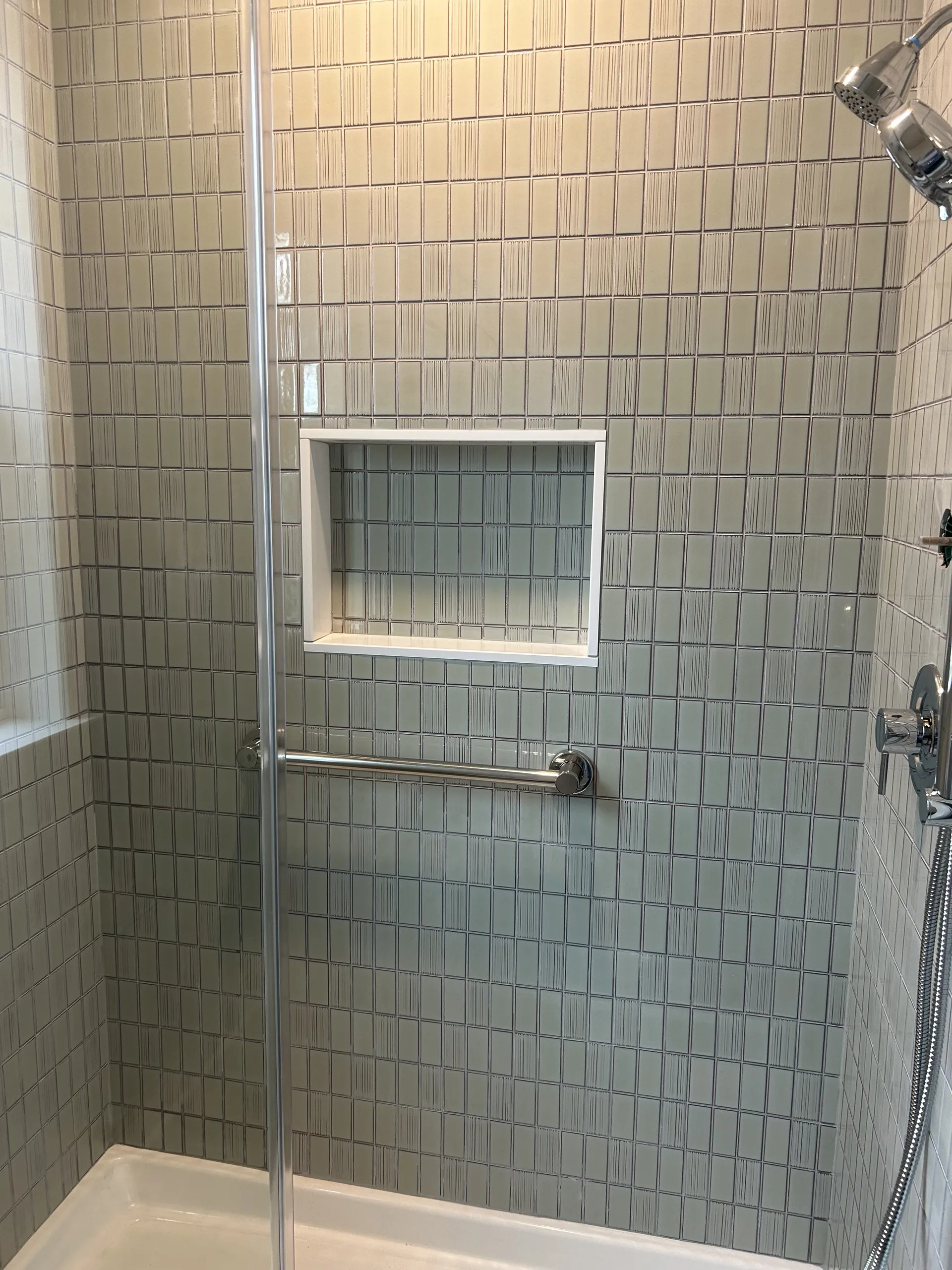Master Bath - Small square tile, frameless shower door, custom niche