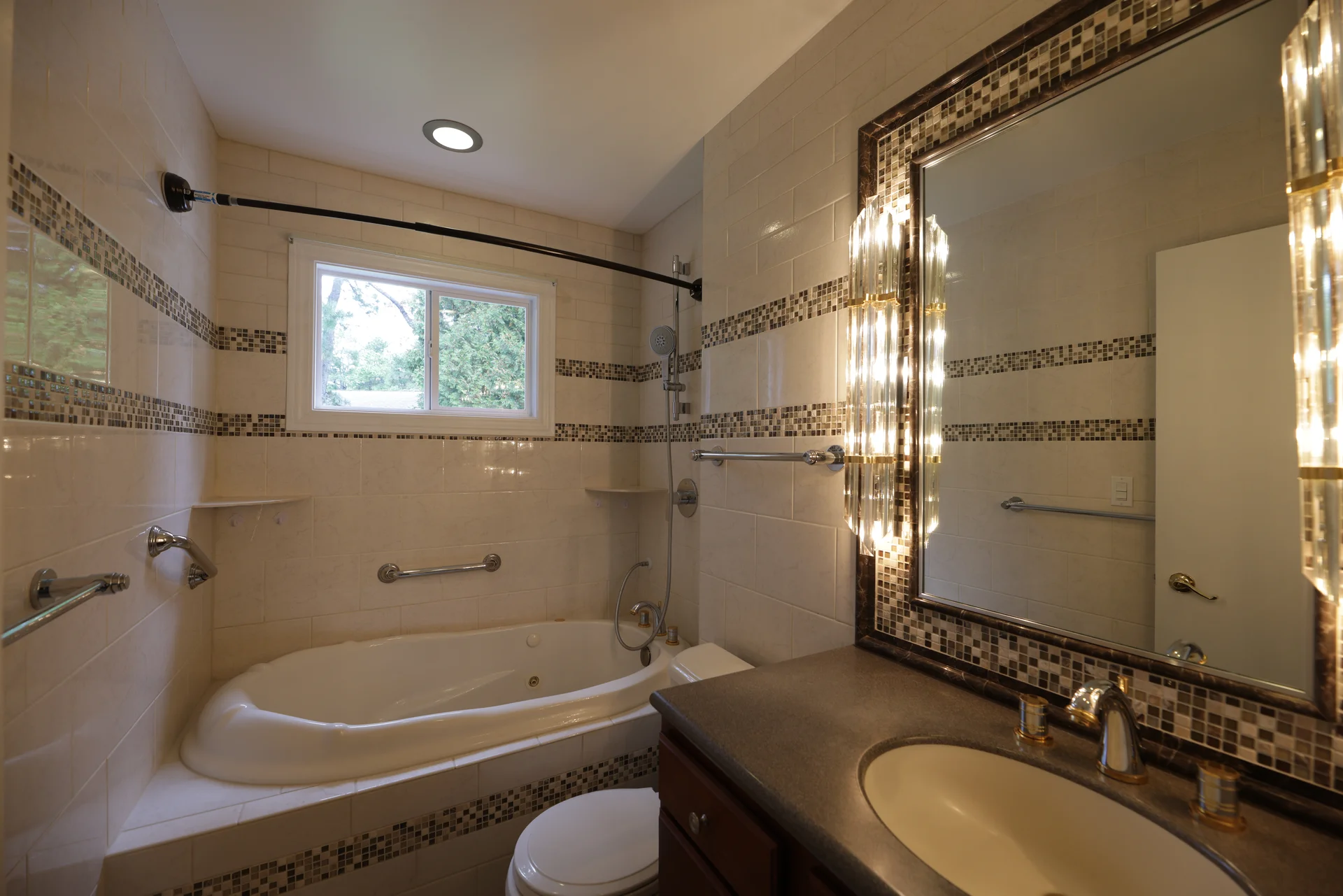 Hall Bath - 3/4 bathroom with custom tiled tub surround, shelves, horizontal tile accent strips, custom mirror